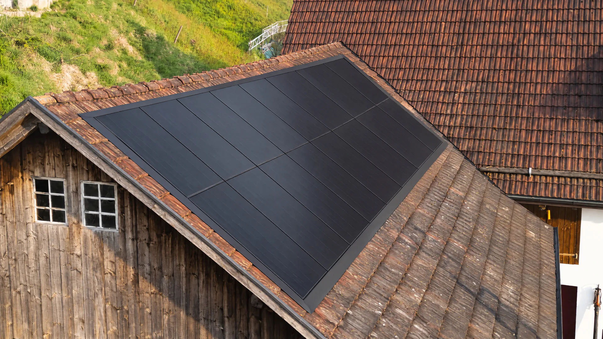 Visualisierung: Holzscheune mit einer Indach-Solaranlage, die schwarzen Module bündig in der Ziegeldeckung eingelassen